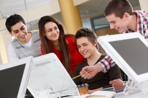 four young students study on computers in a college campus